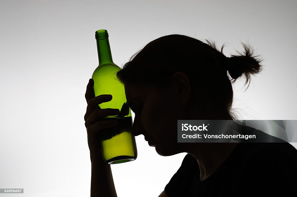 Silhouette of a woman holding a bottle Alcoholic woman's silhouette with a wine bottle Women Stock Photo