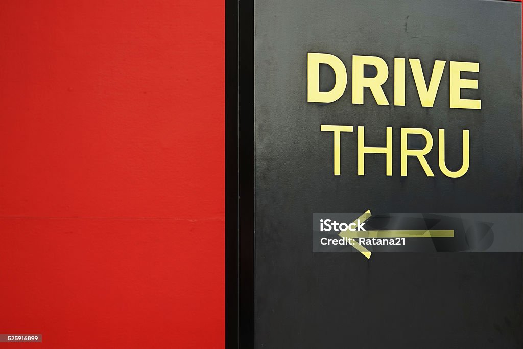 yellow drive thru text with arrow Drive Thru Sign Stock Photo