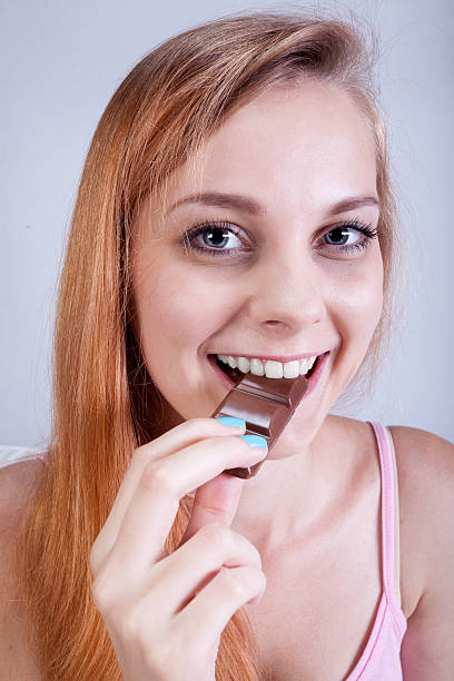 istock Girl eating chocolate bar 525917101
