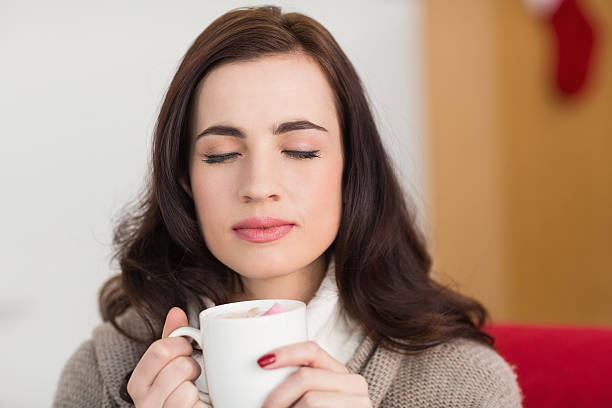 istock Brunette enjoying a hot chocolate with marshmallow 525917513