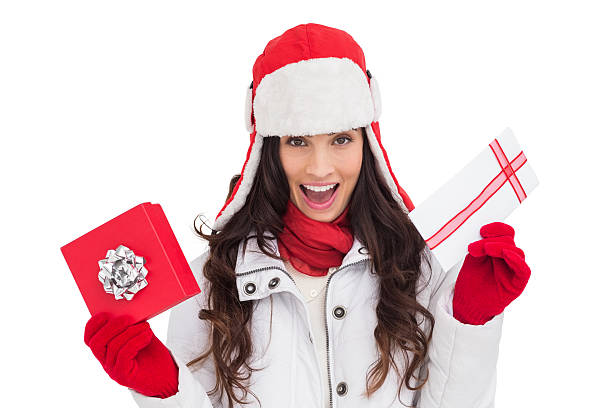istock Excited brunette in winter clothes holding gifts 525919193