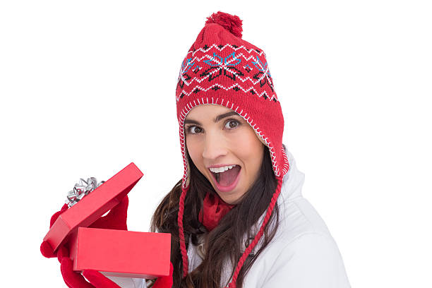 istock Excited brunette opening a christmas gift 525919211
