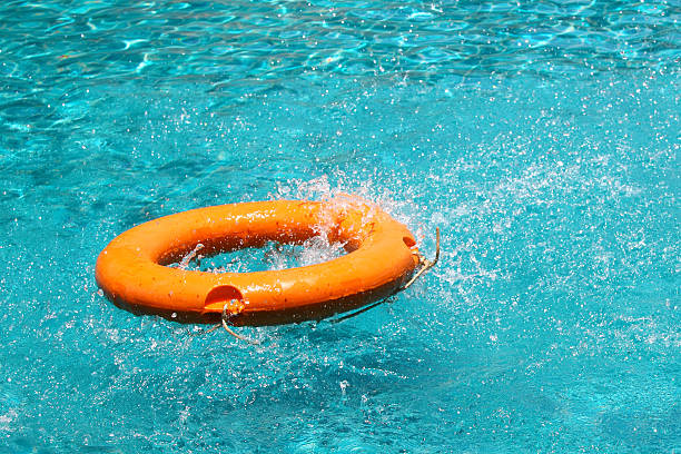 istock Orange life buoy floating on the surface of blue water 525920133
