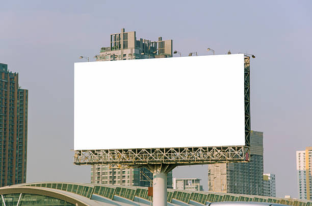 istock large blank billboard on road with city view background 525934919