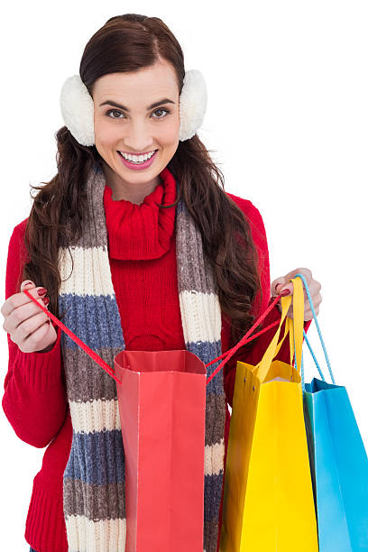 istock Brunette in winter clothes holding shopping bags 525937183