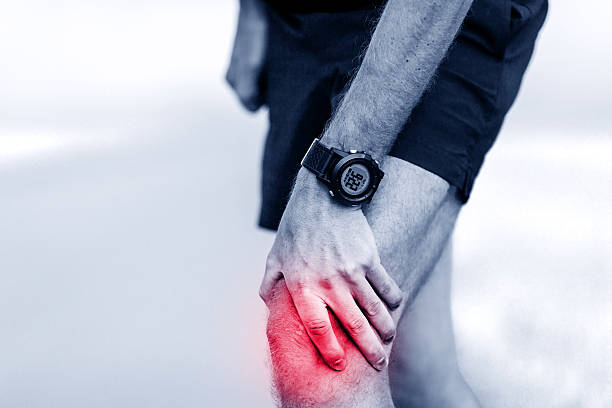 Running injury, knee pain stock photo