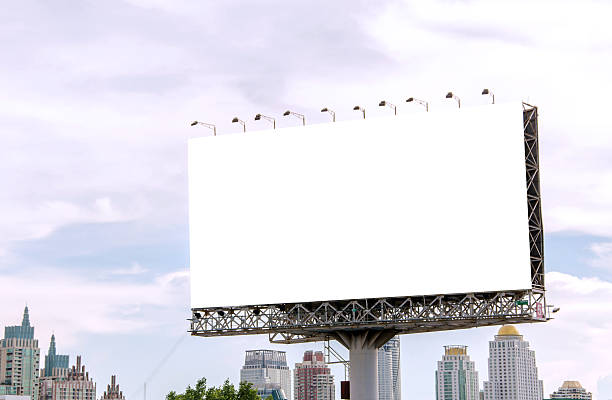 istock large blank billboard on road with city view background 525937299