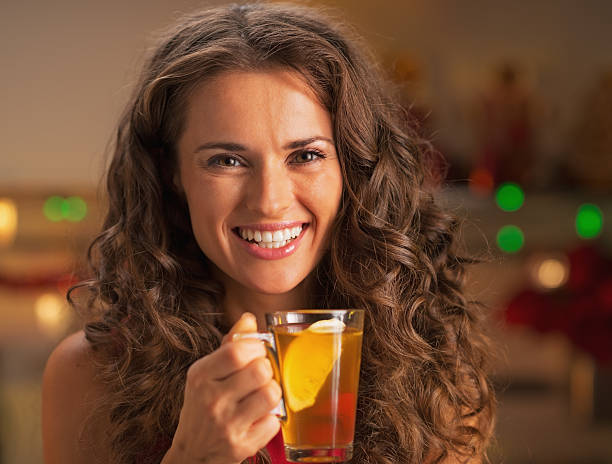 istock Smiling young woman with cup of ginger tea 525938115