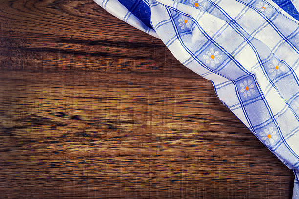 istock Top view of checkered napkin on old wooden table 525938183