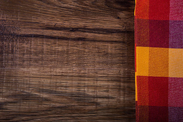 istock Top view of checkered napkin on old wooden table 525939641