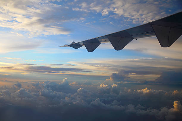 istock Wings of an airplane in the sky 525940271