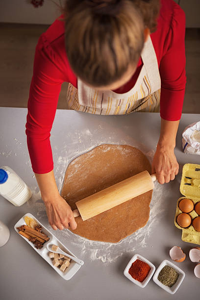 istock young housewife rolling pin dough in kitchen 525941049