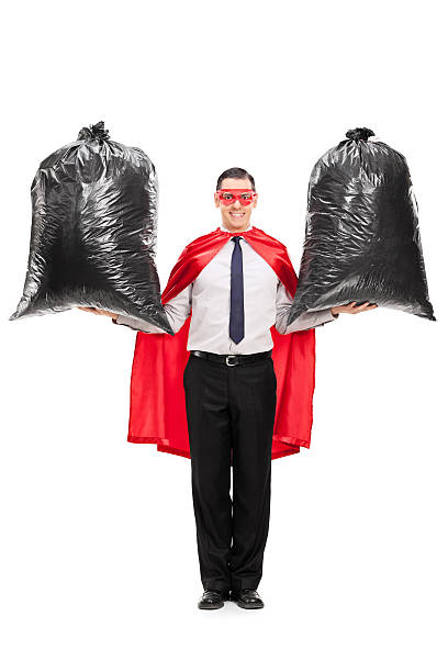 istock Young superhero holding two trash bags 525949641