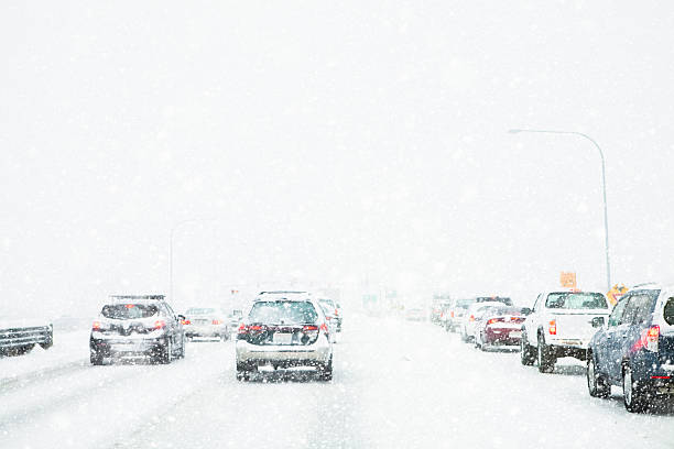 istock Slow moving freeway traffic during a winter snow storm blizzard 525950447