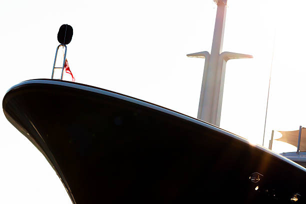 istock Bow of black luxury yacht, white background with copy space 525950877