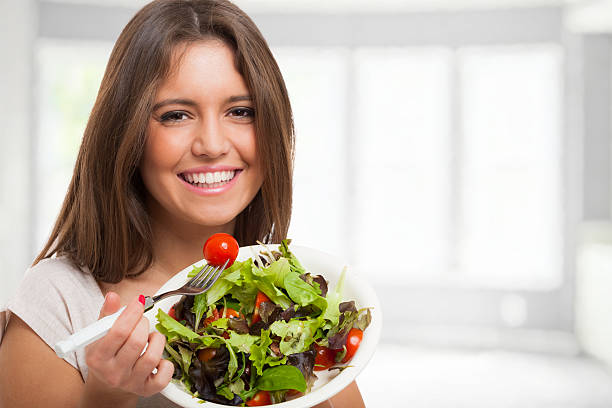 istock Woman eating a healthy salad 525951751