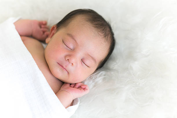 Newborn Baby Beautiful newborn baby sleeping peacefully. biracial newborn stock pictures, royalty-free photos & images