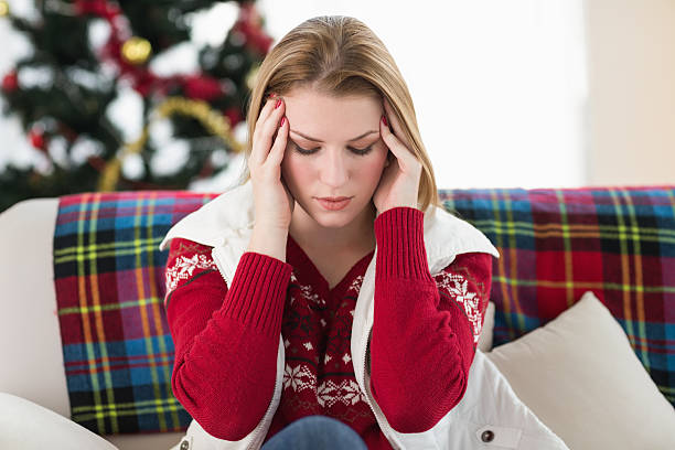 istock Pretty blonde woman having a headache on the sofa 525952643