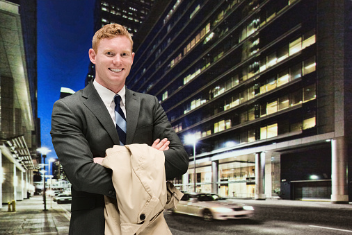 Smiling businessman out in the city at nighthttp://www.twodozendesign.info/i/1.png