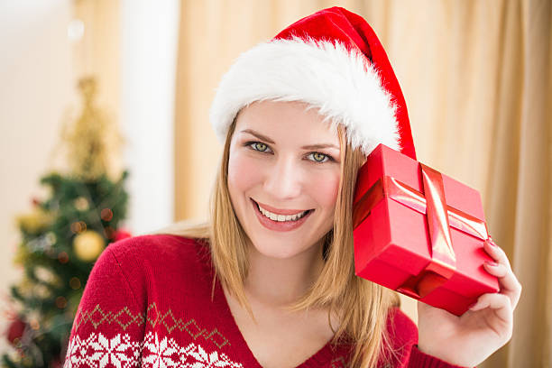 istock Festive blonde holding a gift 525953539