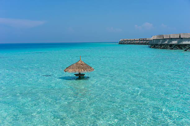 istock Maldives island, water villas resort 525955168