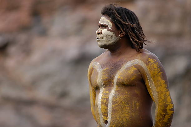 Aboriginal Man Cairns, Queensland, Australia - August 28th, 2005: An Aboriginal Man with body paint, with thoughtful stare in Cairns, Queensland in Australia on 28th August 2005 australian aborigine culture stock pictures, royalty-free photos & images