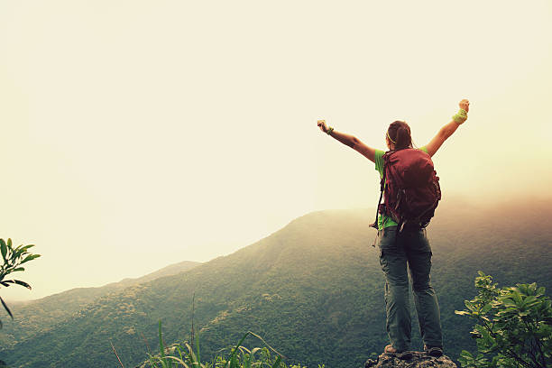 istock cheering woman hiker enjoy the view on mountain peak 525957566