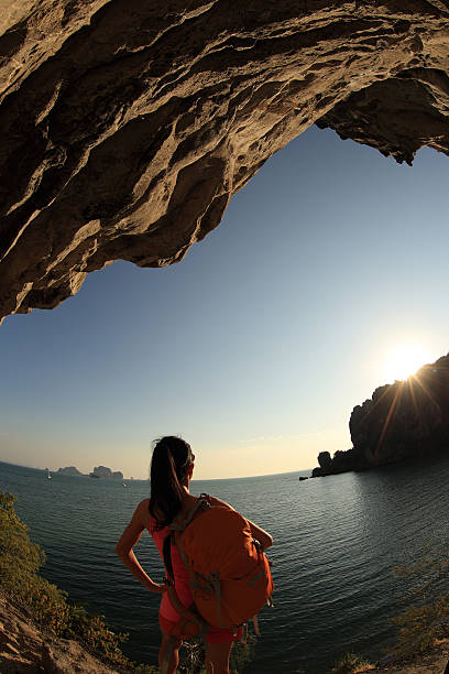 istock young asian woman enjoy the view at sunset seaside 525958018