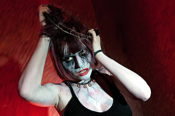 istock girl with a crown of thorns on her head posing 525960760
