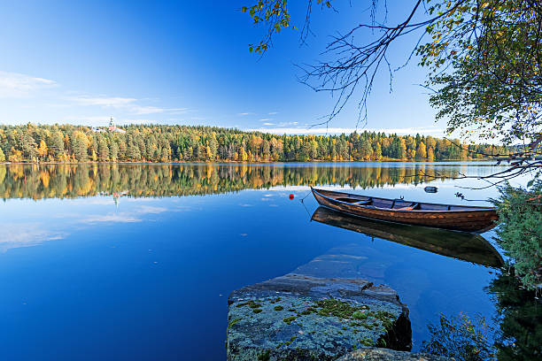 istock Autumn lakes at Norway moored boat 525961810