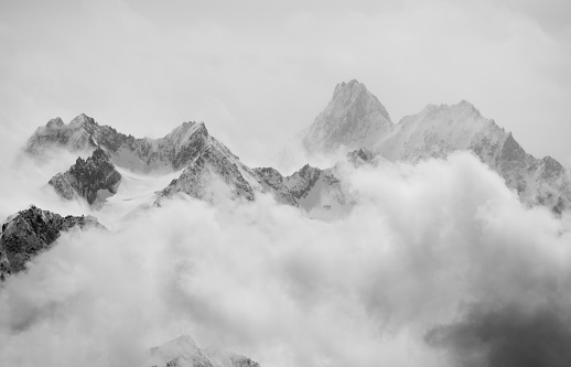 Atmospheric clouds linger around the peaks of the Swiss alps after a spring snow storm.