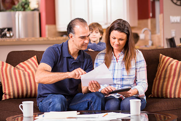 istock Latin descent couple paying monthly bills at home. 525962574