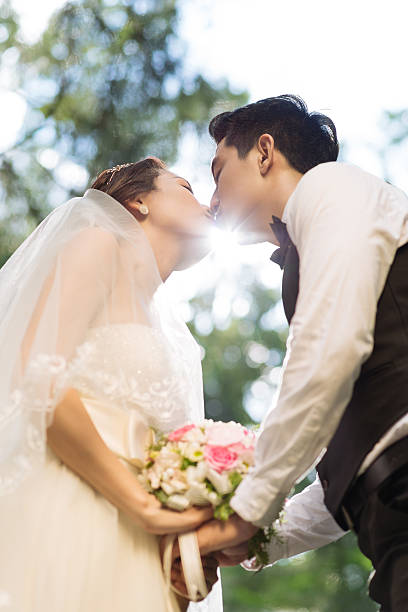 istock Kissing wedding couple 525963245