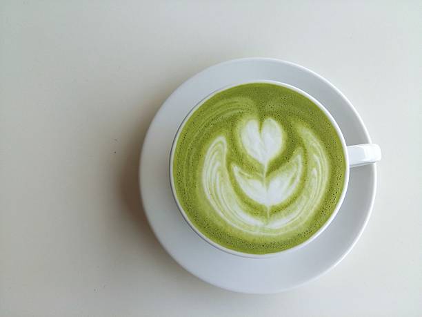 Cup of matcha latte isolated on white background