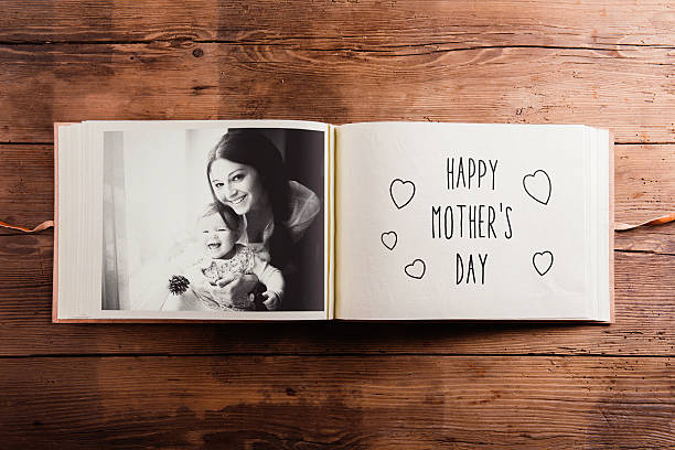 Mothers day composition. Photo album, black-and-white picture. W Mothers day composition. Photo album, black-and-white picture. Studio shot on wooden background. scrapbook stock pictures, royalty-free photos & images