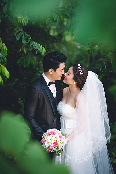 istock Kissing wedding couple 525964425