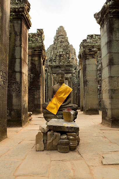 istock Yellow fabrics around Buddha at Angkor Wat temple, Cambodia 525964430