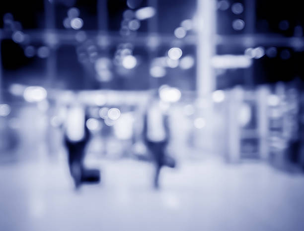 istock blur  people and baggage walking on walkway with light bokeh 525964464