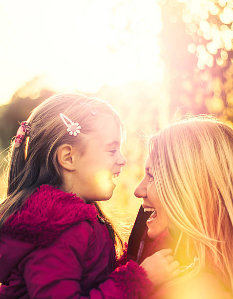 istock Mother and daughter enjoying themselves at sunset 525964970