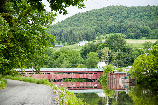 Taftsville covered bridge crossing small river in Vermont hills
