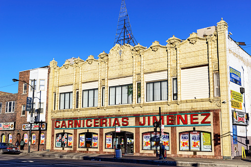 Chicago, USA - November 24, 2013: Old commercial buildings on North Avenue in Humboldt Park, a Chicago community on the West Side. Shop in a hispanic neighborhood. Background people.