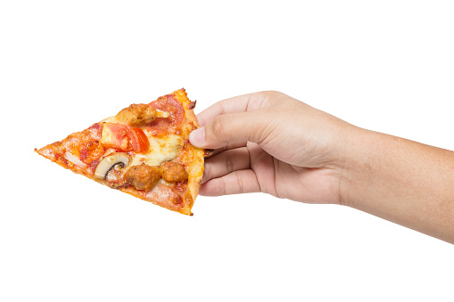 hand holding tasty flavorful pizza isolated on white background