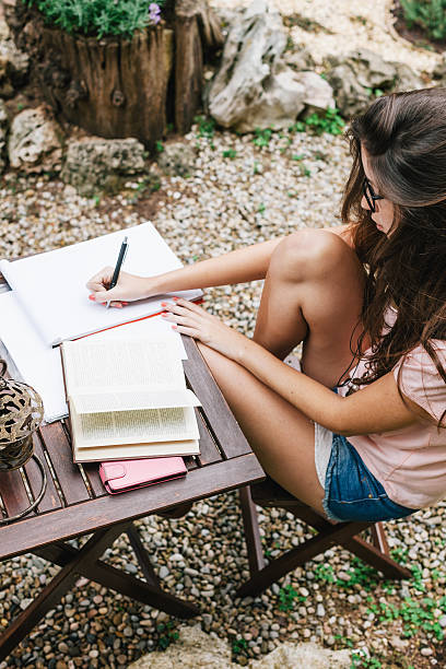 istock Young beautiful female sitting outside and studying hard. 525967339