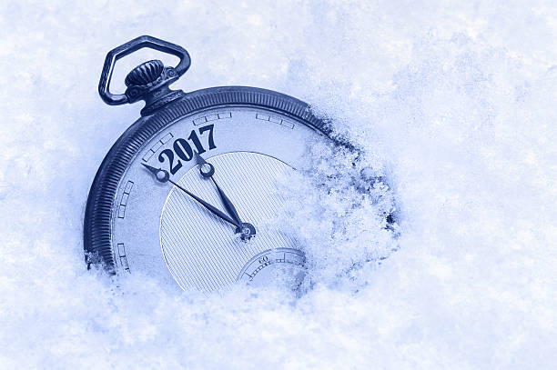 istock Pocket watch in snow, New Year 2017 greeting card 525968144