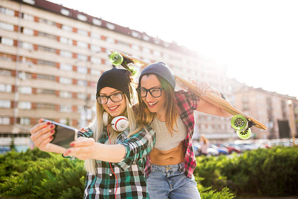 istock Hipster girlfriends taking a selfie in urban city context 525968676