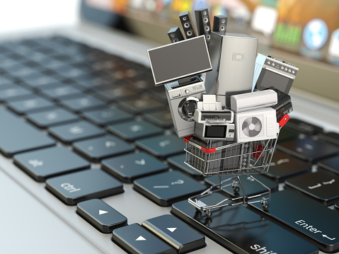 E-commerce or online shopping concept. Home appliance in shopping cart on the laptop keyboard. 3d illustration