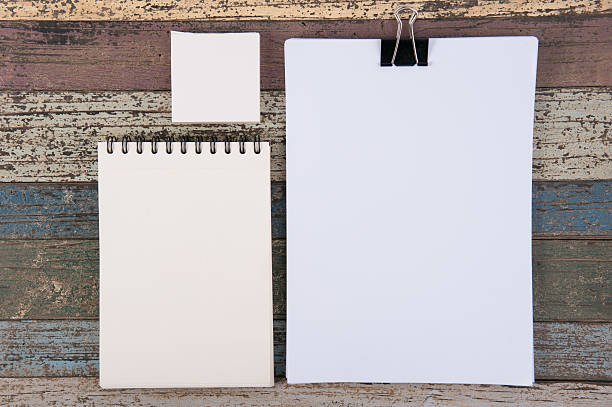 istock Notebook paper and school  tools on vintage wood table 525971252