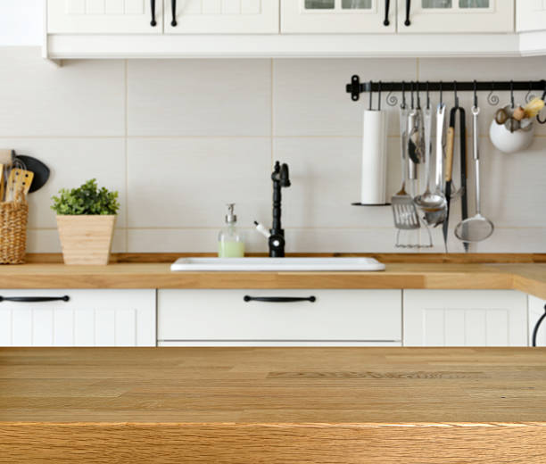 istock Wooden table with kitchen counter and sink background 525971490