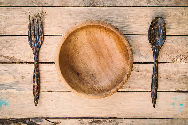 istock wooden bowls and spoon with fork on wood background 525972716