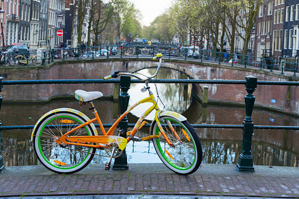istock Orange  bicycle next to canal of Amsterdam 525972828